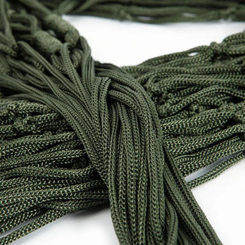 Nylon rope mesh hammock in bold blue on a green background with tie rope and cloth bag