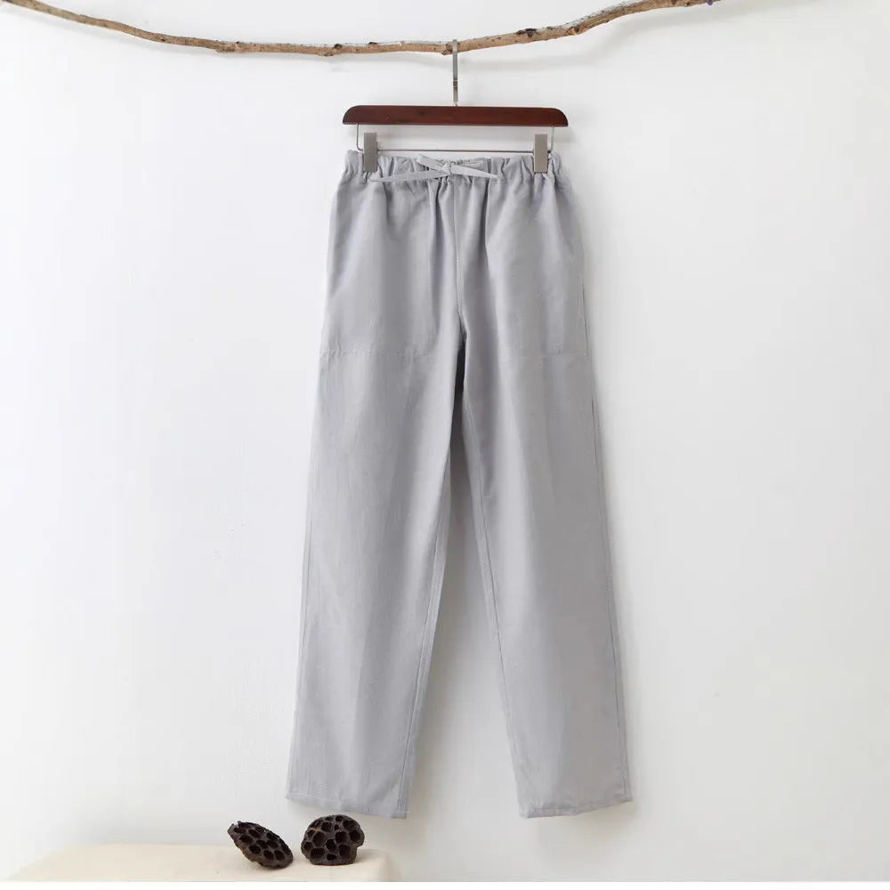 Men's solid colour cotton casual trousers with belt in beige, showing mid waist and drawstring design