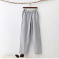 Men's solid colour cotton casual trousers with belt in beige, showing mid waist and drawstring design