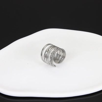 Adjustable stainless steel finger ring with unique charm designs in steel and gold colours