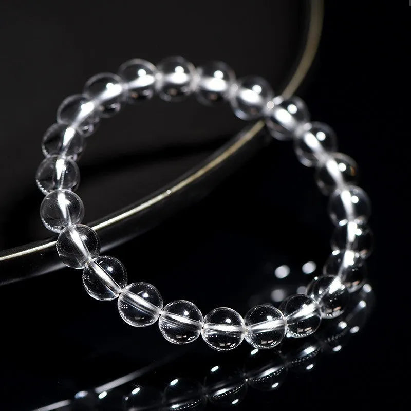 Natural Donghai old mine white crystal round bead bracelet with geometric design on a wrist.
