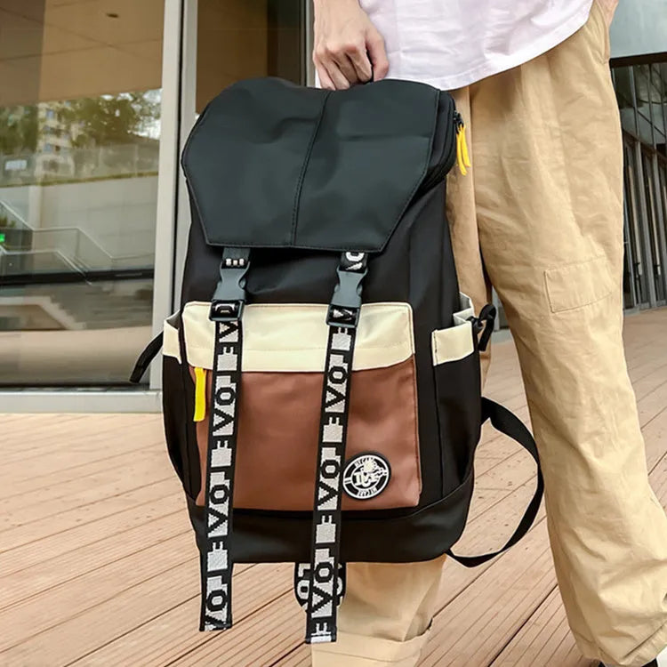 Black oxford cloth backpack with adjustable straps, shown next to green and red colour options.