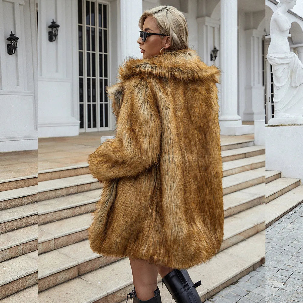 Yellow women's mid-length faux fur coat with a loose fit and regular sleeves on a hanger.