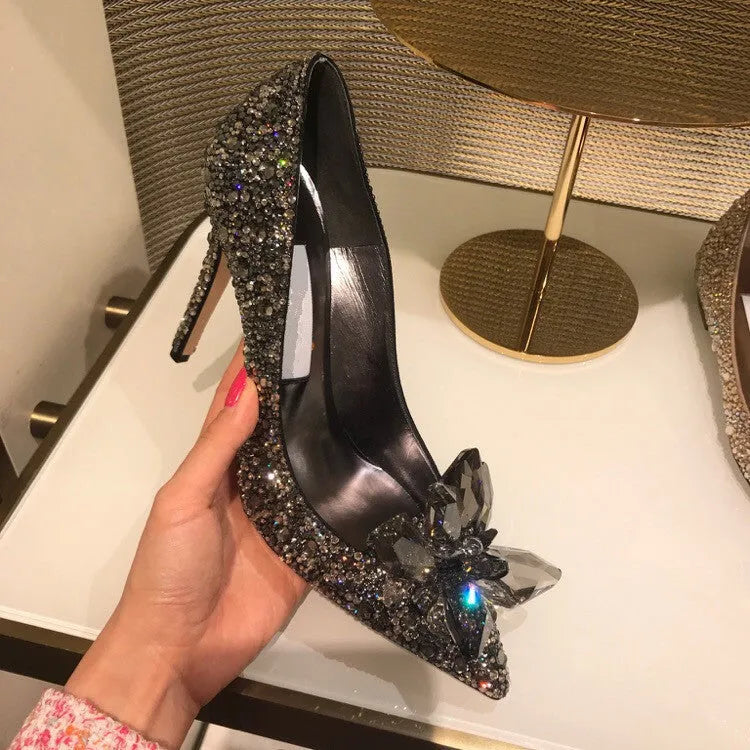 Women's gold sequinned pointed toe high heels with rhinestone details and a stiletto heel.