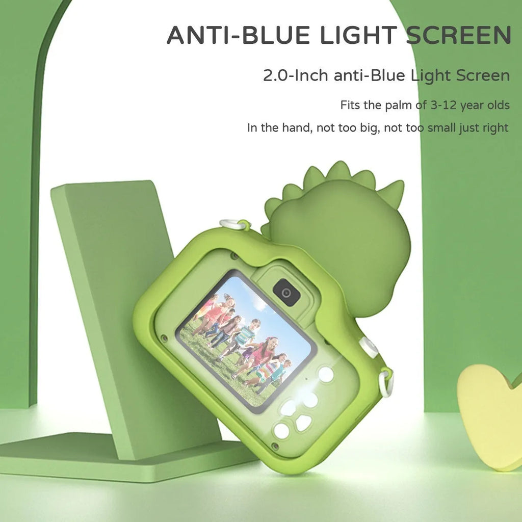 Children's mini cartoon camera with silicone body, Big Head Dinosaur colour, with lanyard and charging cable on white background