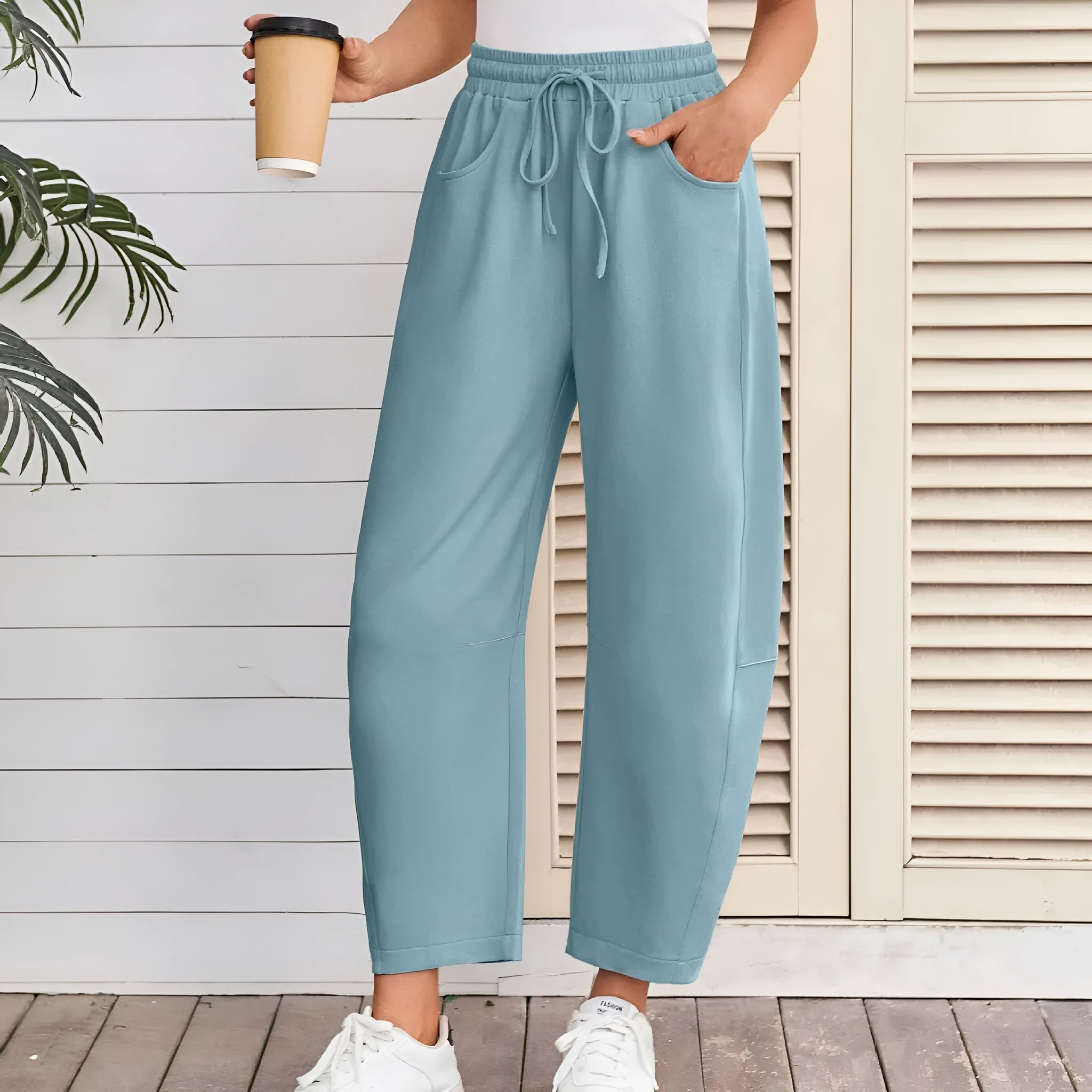 Loose cropped sports sweatpants with elastic waistband and drawstring pockets in street fashion style