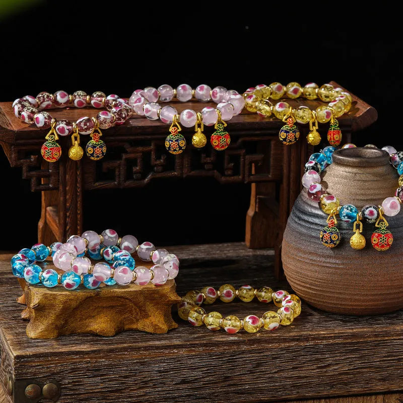 Handmade glass bracelet with swallowing gold beast design and 10mm heart-shaped beads in fluorescent glaze