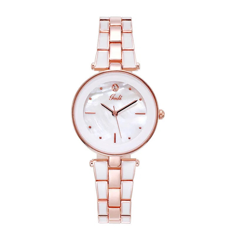 White dial ladies quartz watch with rose gold accents, steel strap, 30mm round alloy case on flat surface