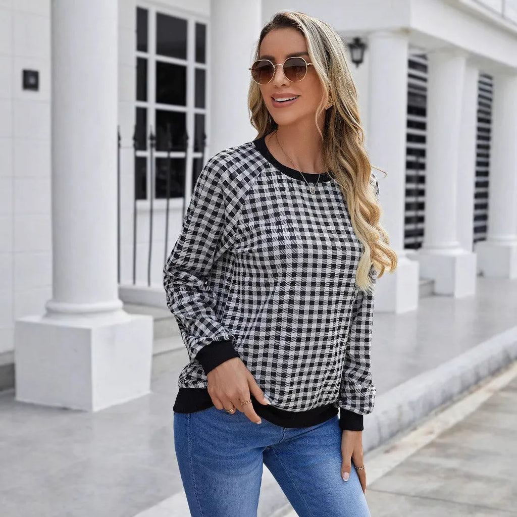 Black long sleeve pullover sweater with a printed plaid stripe pattern on a mannequin.