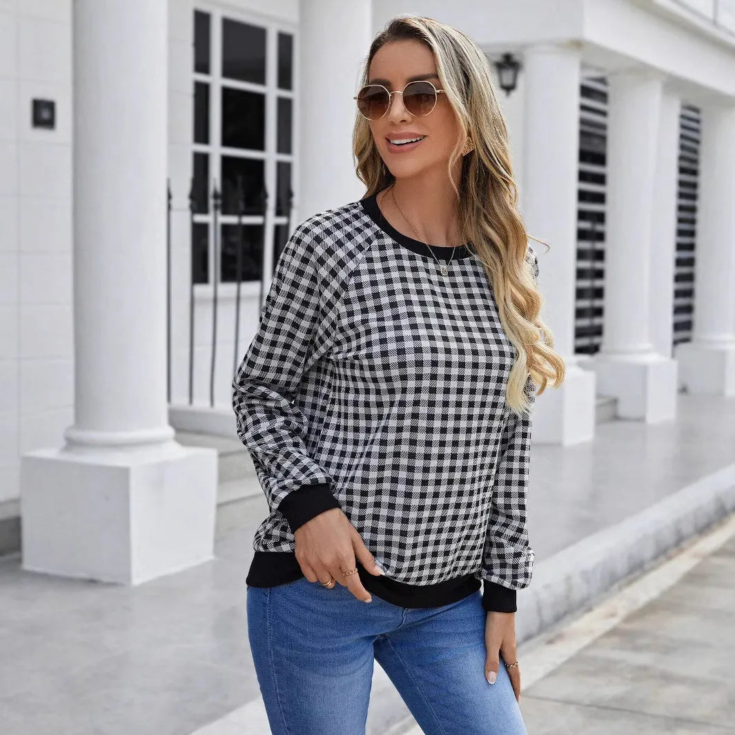 Black long sleeve pullover sweater with a printed plaid stripe pattern on a mannequin.