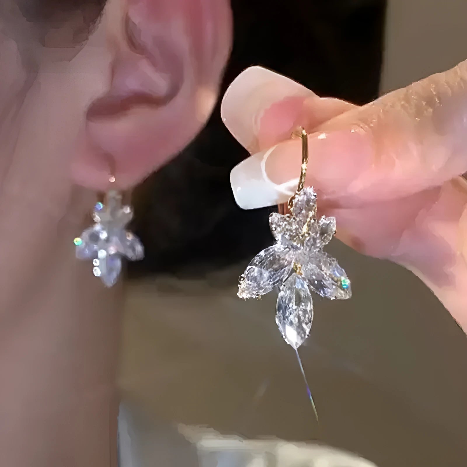 Women's platinum-colour leaf earrings with inlaid shiny zircon stones.
