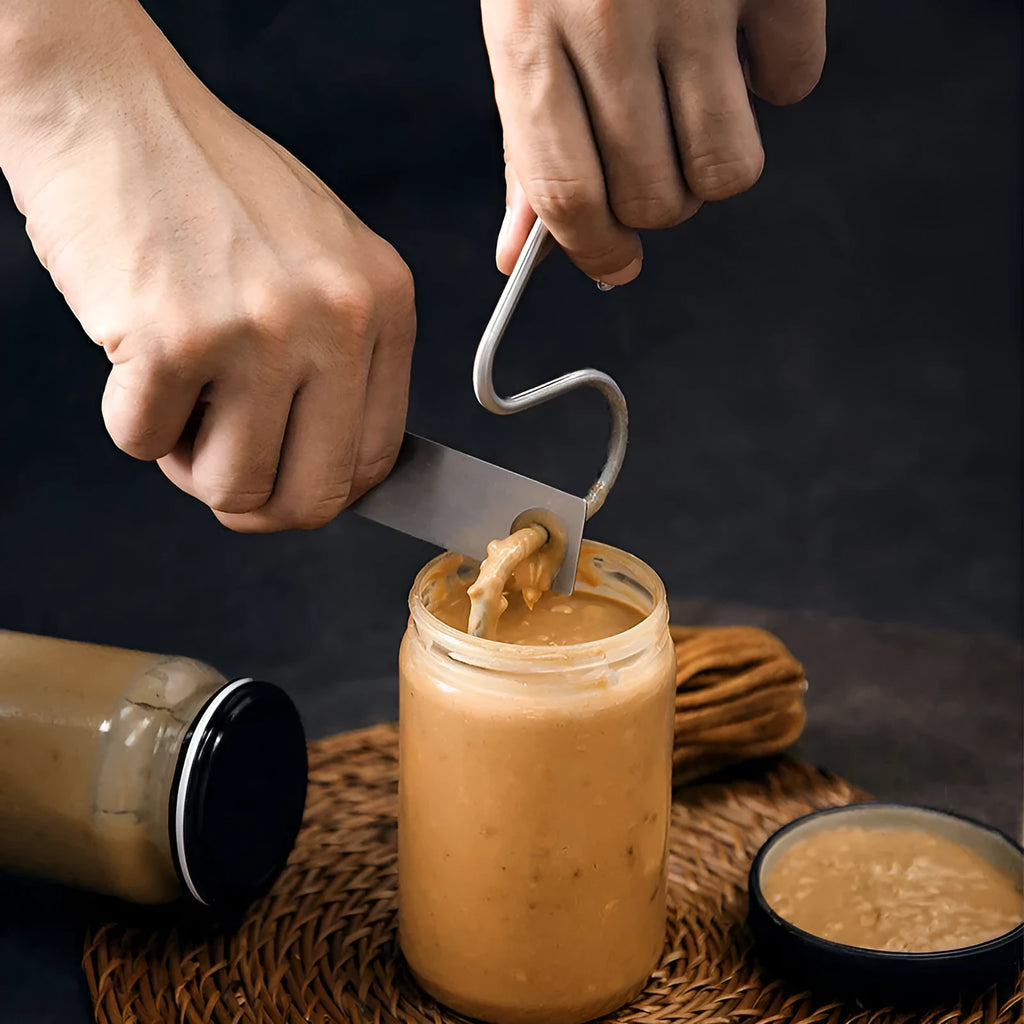 Stainless steel peanut butter mixer sauce stirring rod on white background