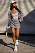 Women's blue polyester hooded jacket and mini skirt co-ord set on a hanger.