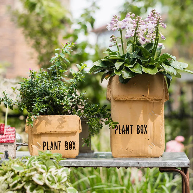 Cement brown paper box style flowerpot with drainage holes for indoor plants.