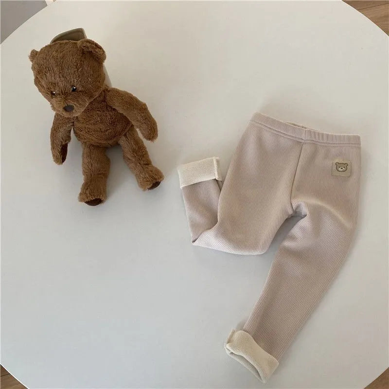 Girls solid colour fleece-lined leggings with high waist and hair band belt, shown in beige, black, brown, grey.