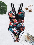 Women's black floral print one-piece swimsuit with a backless design.