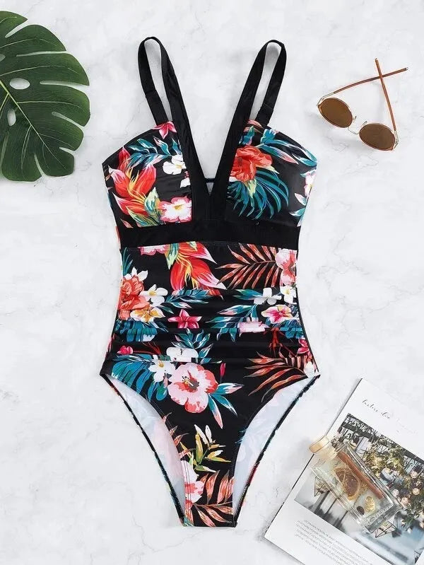 Women's black floral print one-piece swimsuit with a backless design.