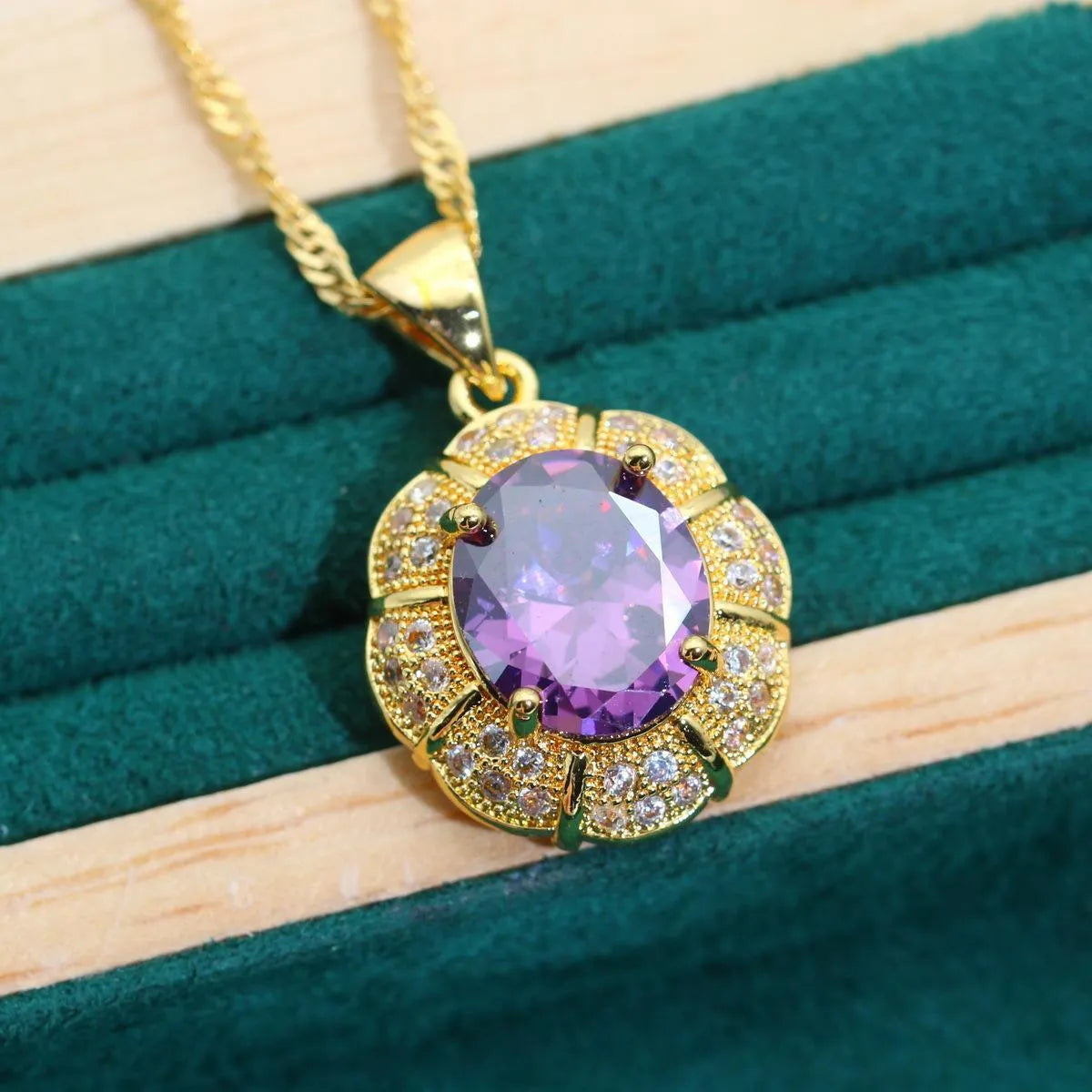 Gold plated jewellery set with coloured cubic zirconia stones showing necklace, earrings, ring, and bracelet.