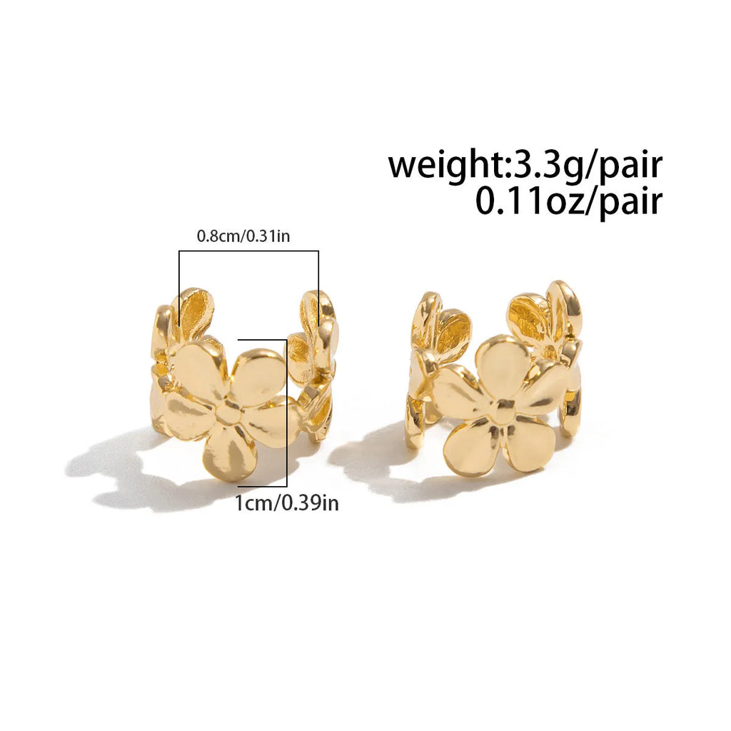 A pair of gold drop earrings featuring a detailed starfish and conch design on an alloy base.