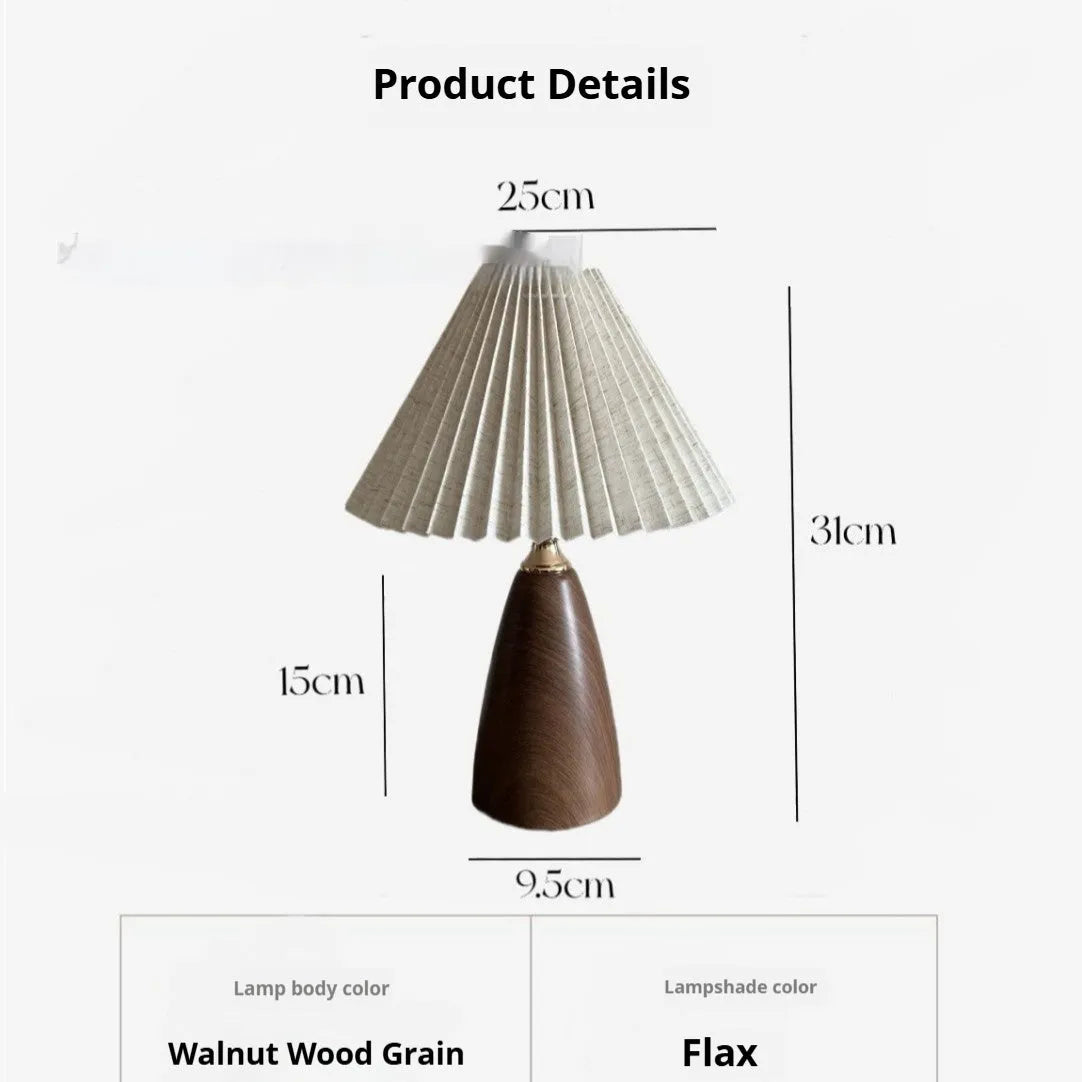 Tapered floral ceramic table lamp with remote control on a wooden surface.