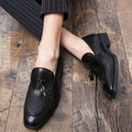 Men's black pointed slip-on shoes with tassel detail on a low-top PU upper