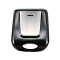 Black nut roasting machine for peanuts and hazelnuts on a kitchen counter.