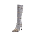 Women's grey knee-high boots with a thin high heel on a white background.