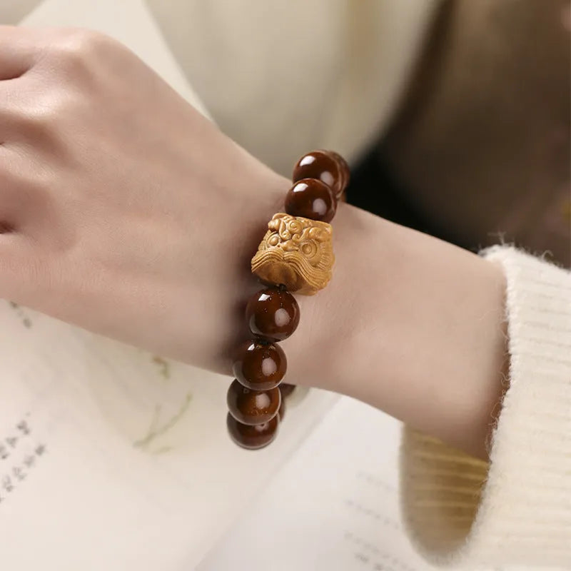 Ivory nut lion style round bead bracelet with 13mm natural seed beads in hand-woven construction