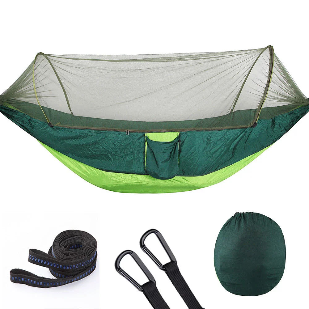 Quick-setup hammock with mosquito net for outdoor adventures, featuring durable materials and easy setup.