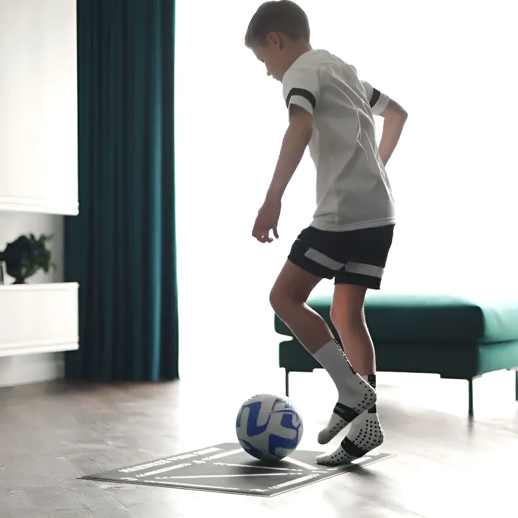 Black rectangular football training mat with non-slip base measuring 60 by 90 centimetres
