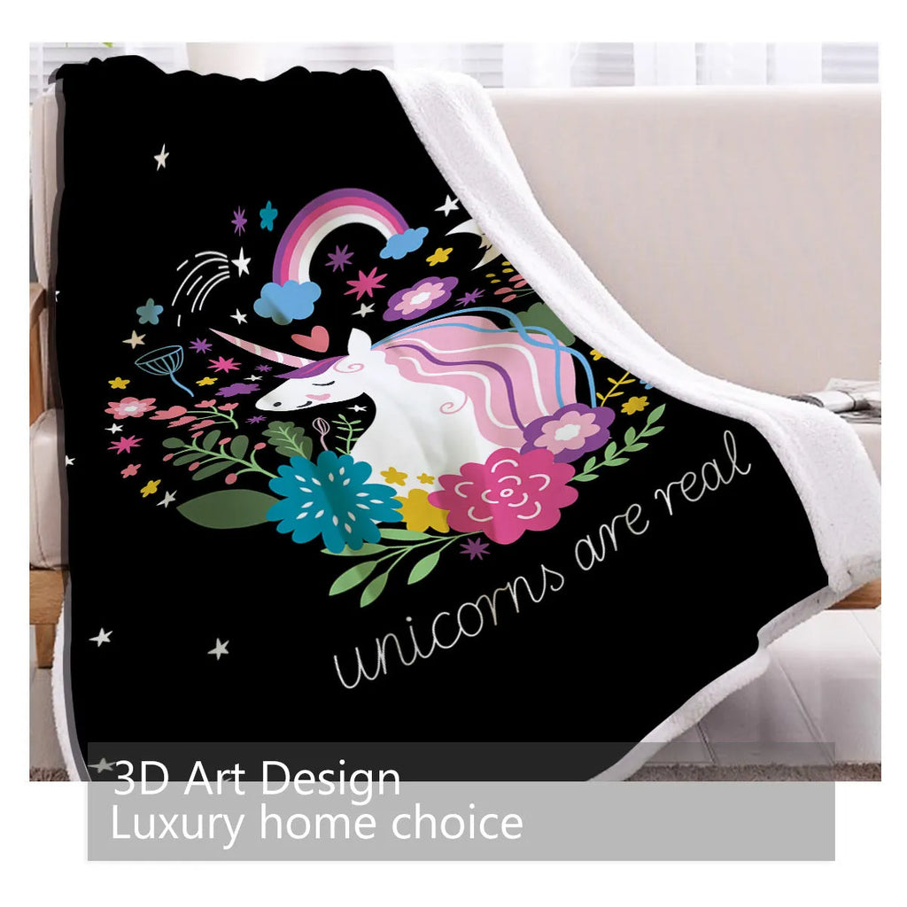 Black sherpa fleece blanket folded on a couch, soft fabric with hemmed edges.