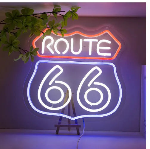 66 Highway LED neon word sign emitting warm white glow against a dark background