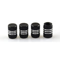 Set of coloured aluminium alloy car tyre valve caps in stainless steel on a grey background.