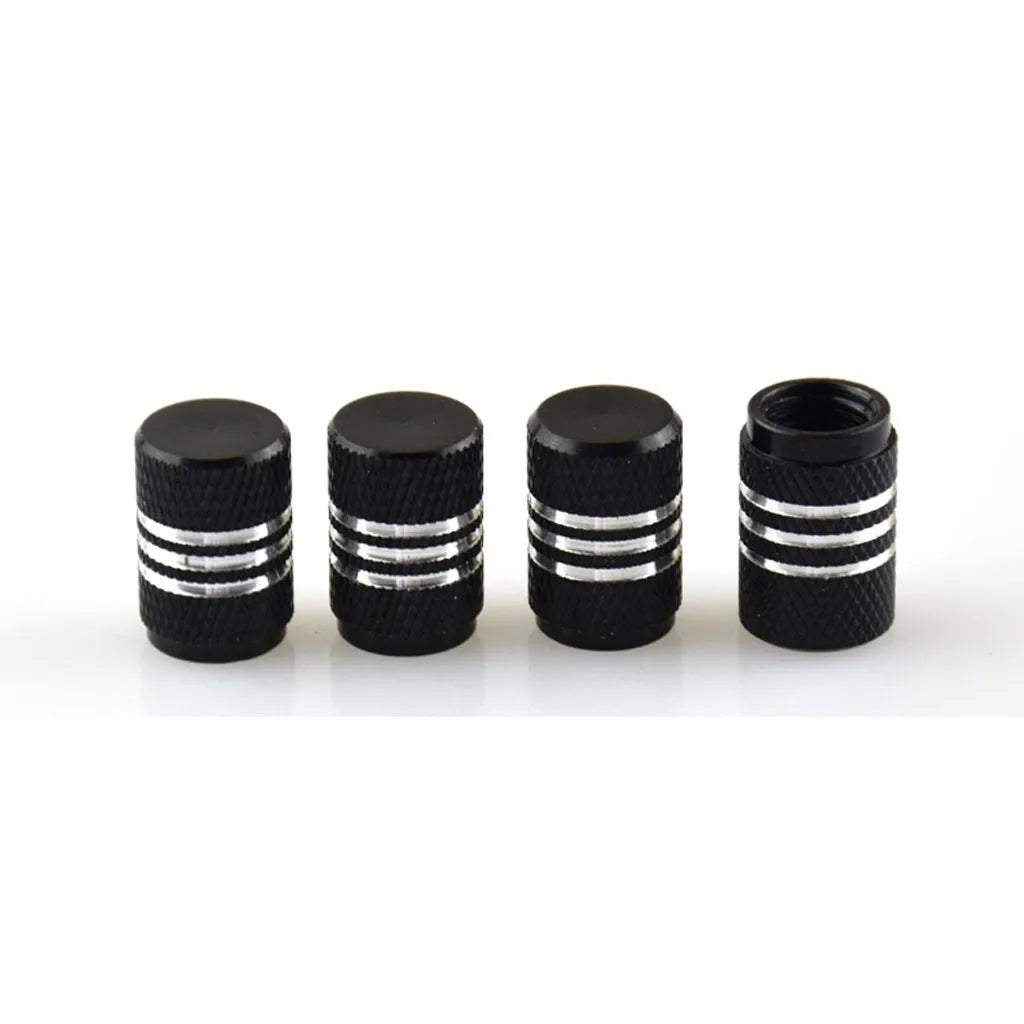 Set of coloured aluminium alloy car tyre valve caps in stainless steel on a grey background.