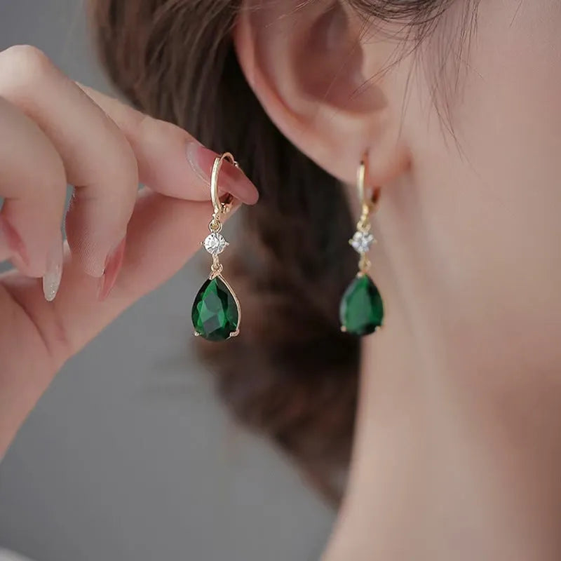 Green geometric teardrop clip-on earrings with gold plating.