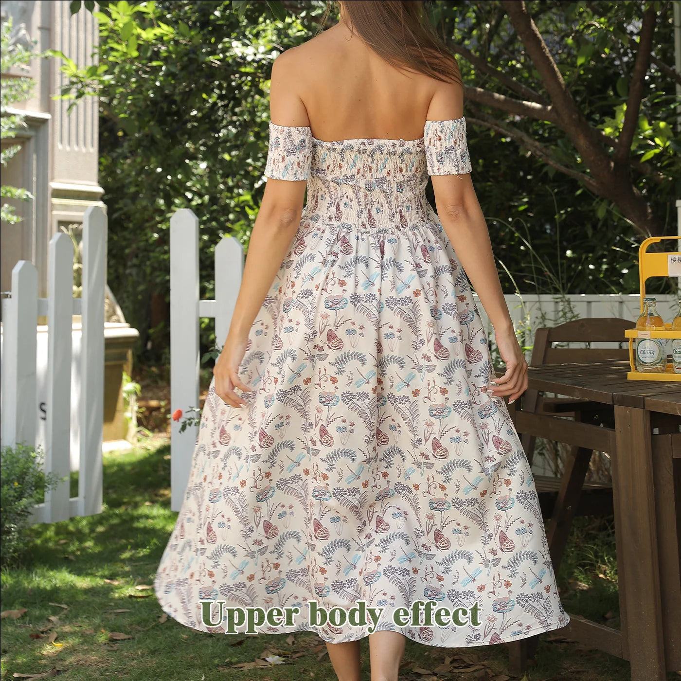 Women's off-shoulder strapless floral dress in a vibrant pattern, perfect for summer outings.