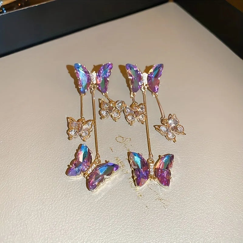A pair of women's silver-plated alloy tassel drop earrings with crystal flowers in a blue purple butterfly colour.