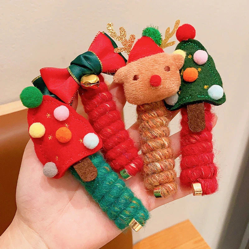 Festive Christmas hair ties for girls in various holiday-themed designs, including red bells, green trees, and khaki deer.