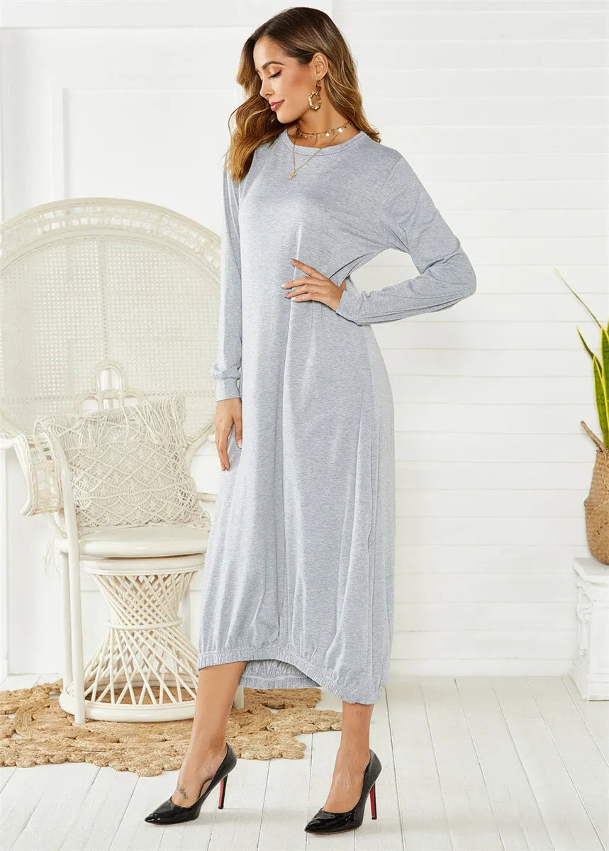 A loose, black lantern-style dress with a lace-up detail on the crew neckline.