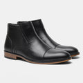 Men's brown Chelsea ankle boots with a side zip, shown on a foot.