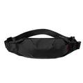 Black Oxford cloth waist pack for men worn crossbody, showing front zip and compact size.