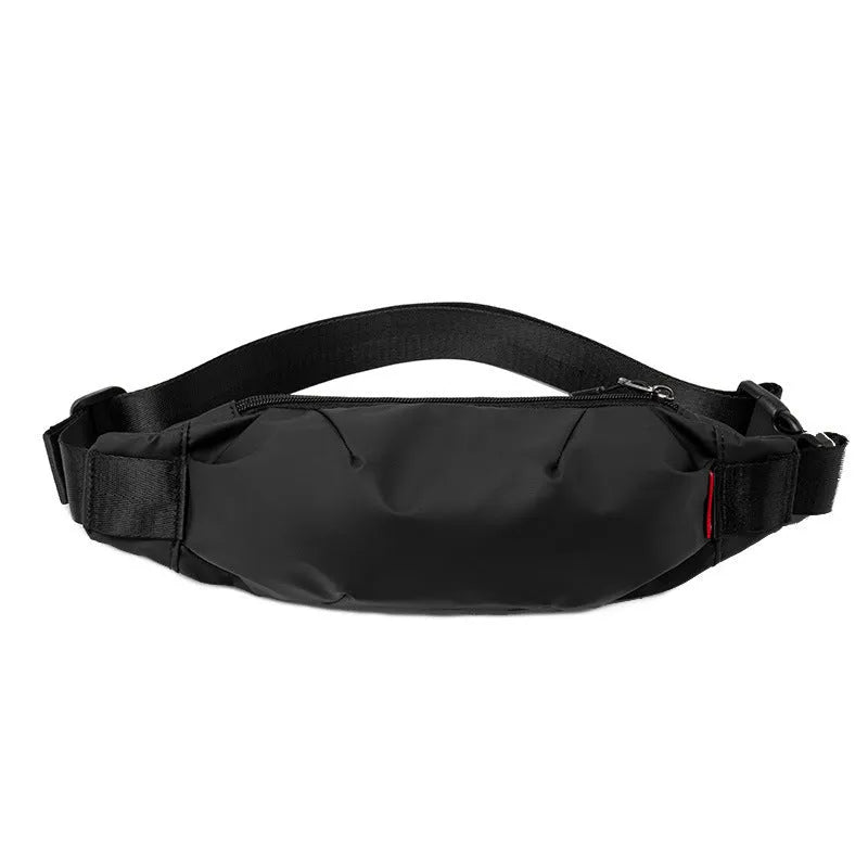 Black Oxford cloth waist pack for men worn crossbody, showing front zip and compact size.