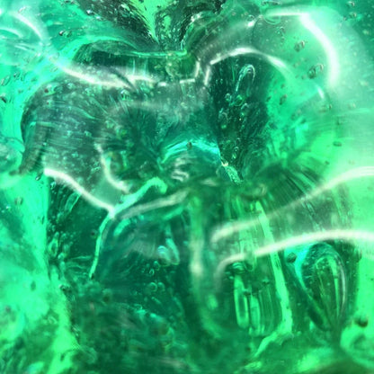 Gradient multicolor crystal mud slime in a plastic box, showcasing its vibrant colors and smooth texture