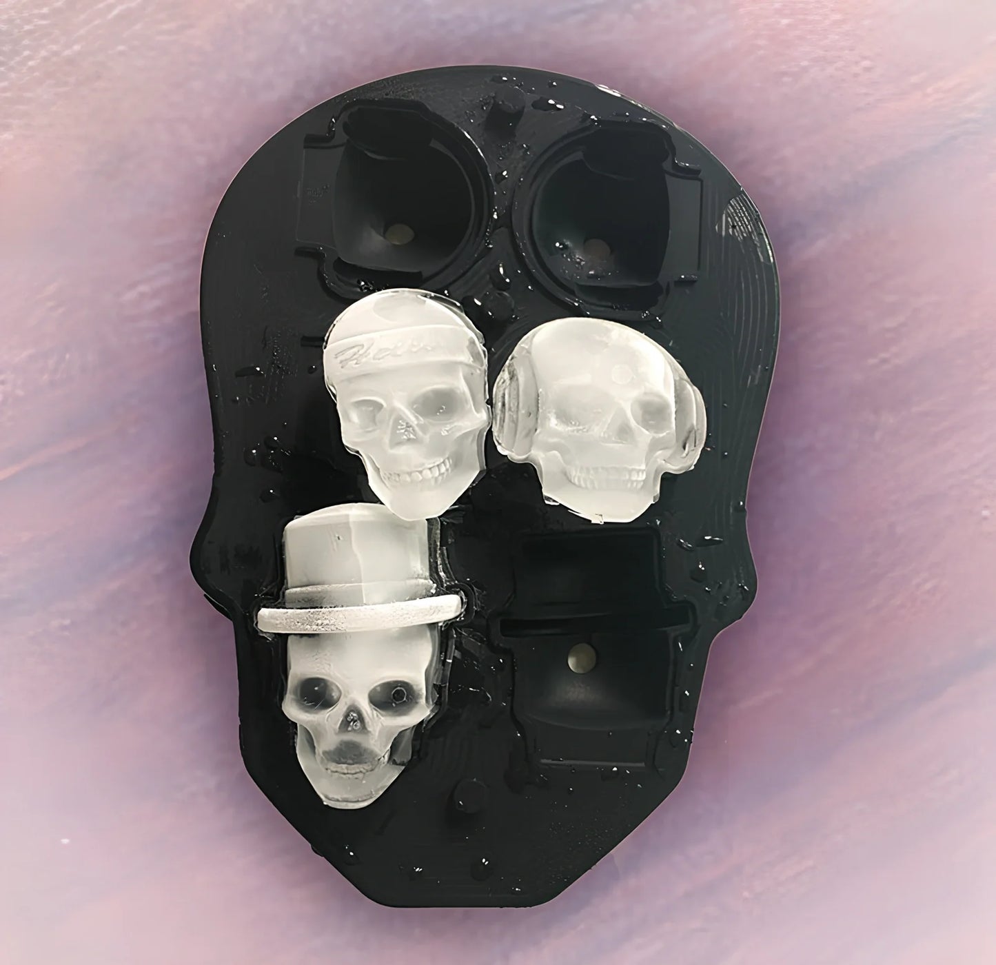 Black silicone ice cube tray with four skull-shaped cavities measuring 12cm long