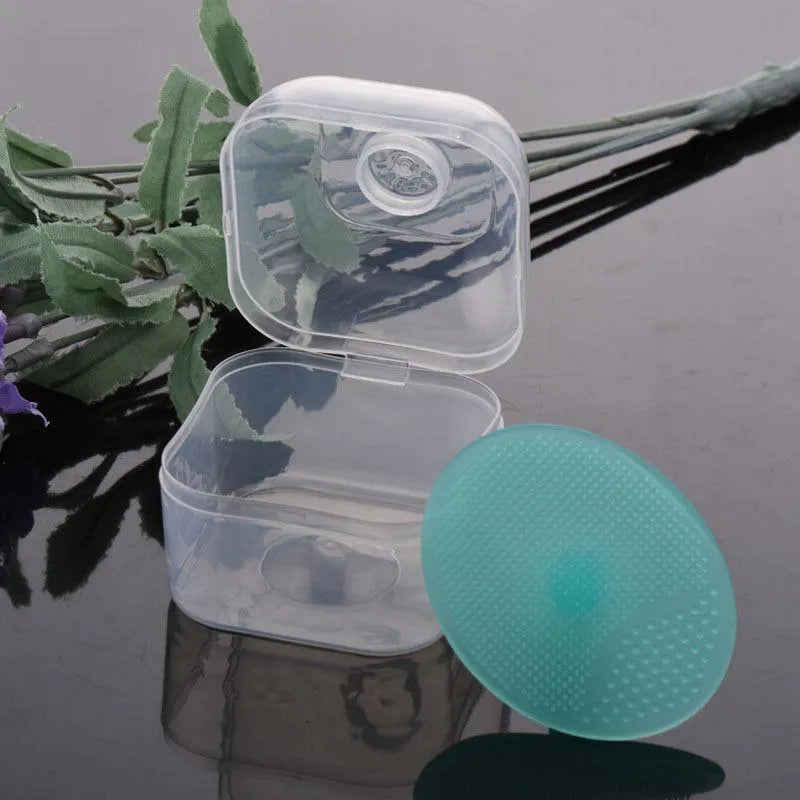 Silicone facial brush in three bristle zones with suction cup on blue background