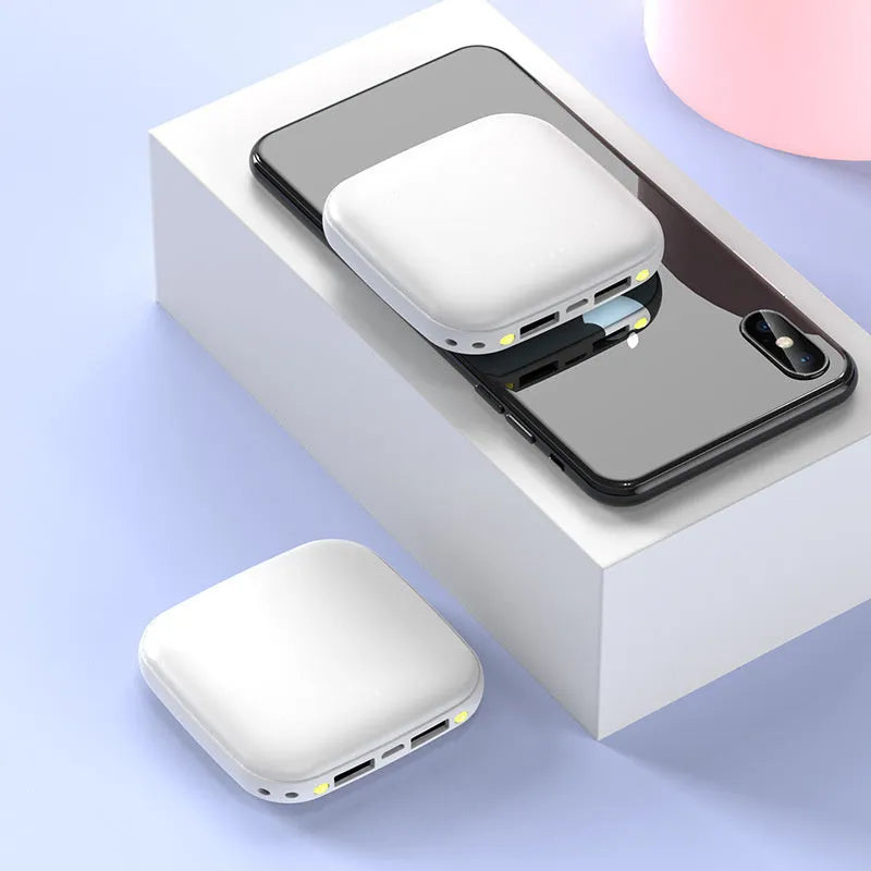 Portable 10000mAh power bank with multi-USB ports in black, white, blue, and pink colours