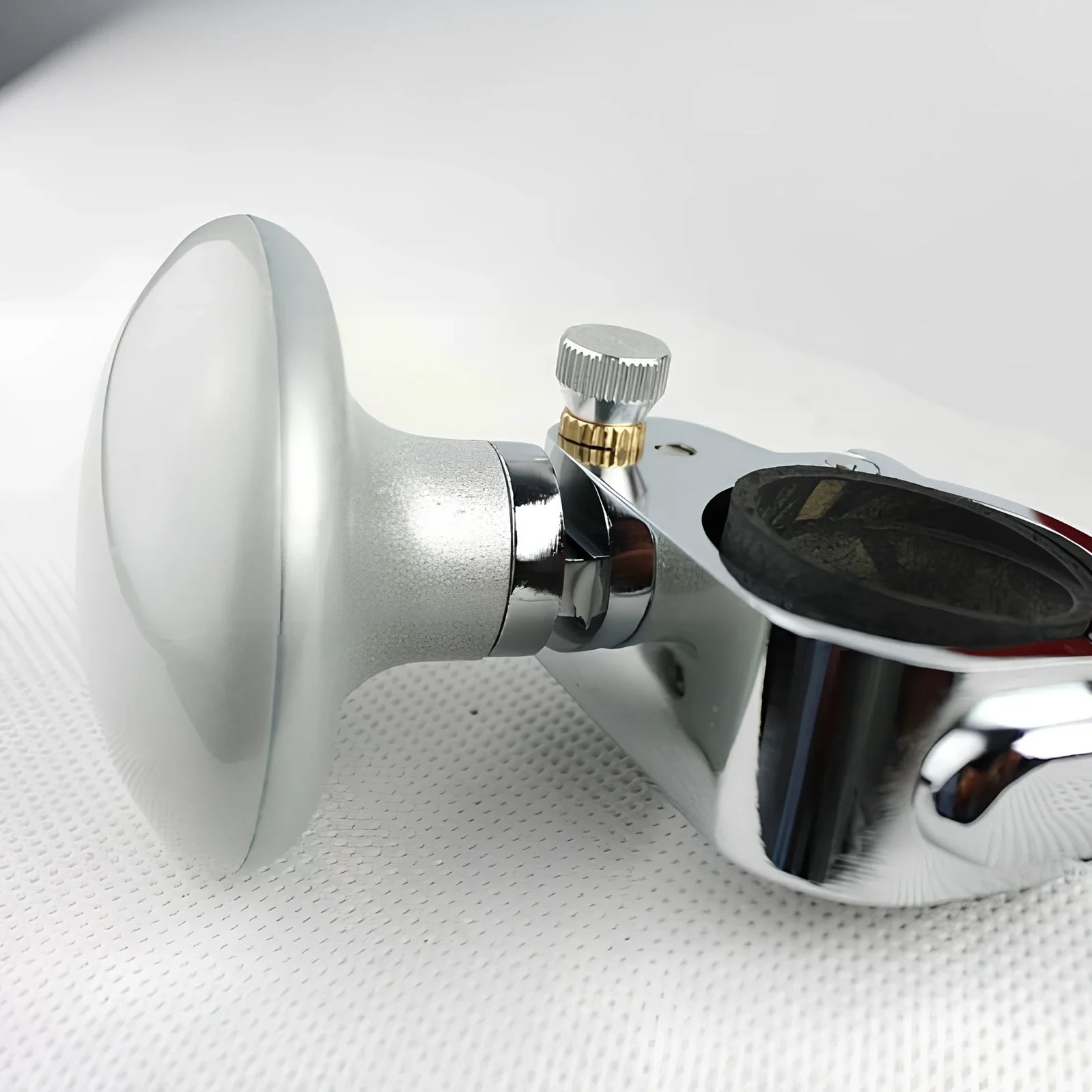 Adjustable stainless steel steering wheel booster in black, fitting up to 32mm thick rims for cars