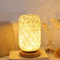 Dimmable LED night light with wooden twine vine finish on a bedside table, warm light, beige lampshade