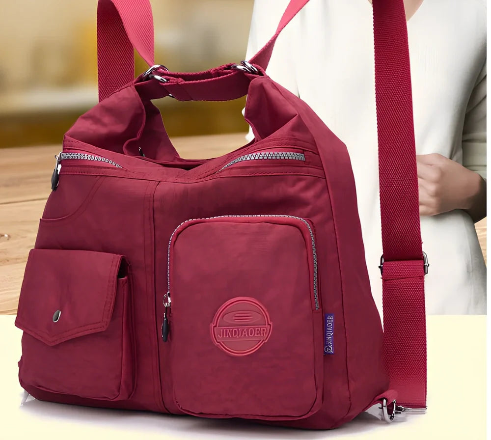 Women's waterproof nylon crossbody bag with organizational pockets and 34cm laptop capacity