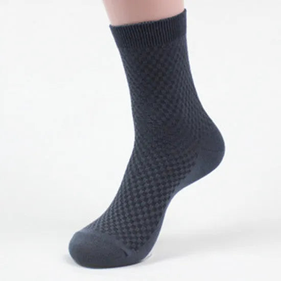 A pair of men's bamboo fibre ankle socks with a small square pattern, shown in one of the five available colours.
